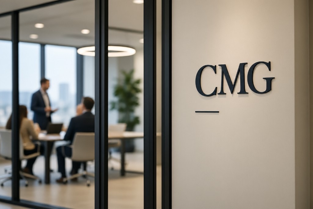 CMG office with the brand mark on a glass wall and a meeting underway beyond